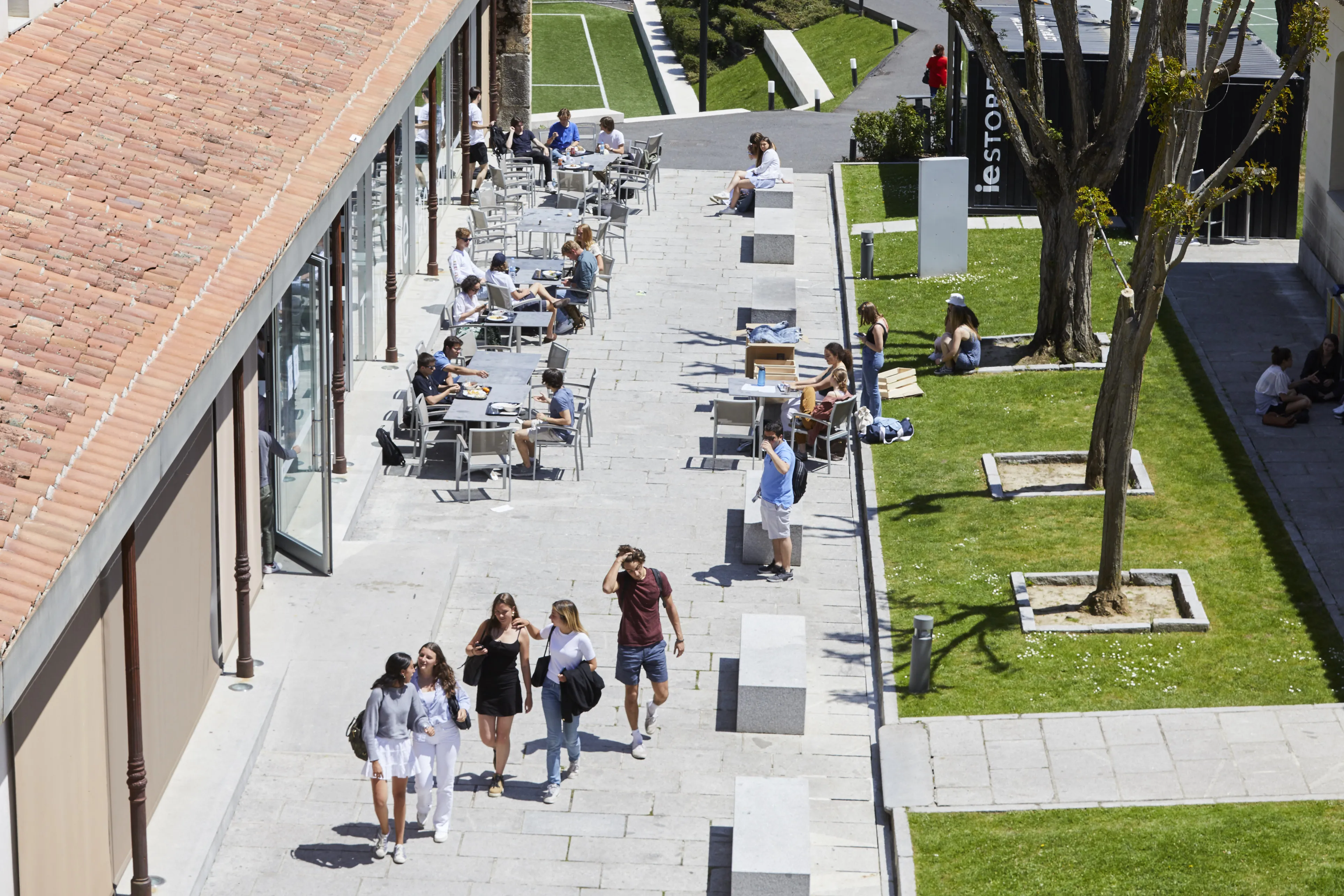 Fachada acristalada del IE Tower reflejando el cielo de Madrid